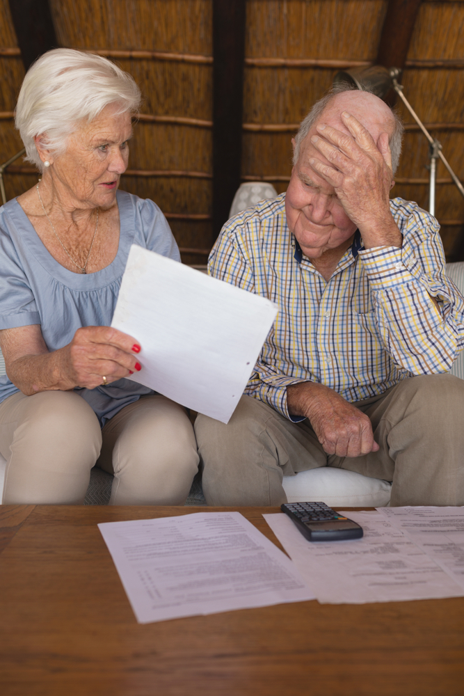 Older couple stressed out over medical bills.